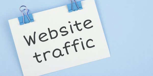 Inscription Website traffic. Note written on a white sticker with paper clip.