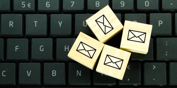wooden cube with email icon.